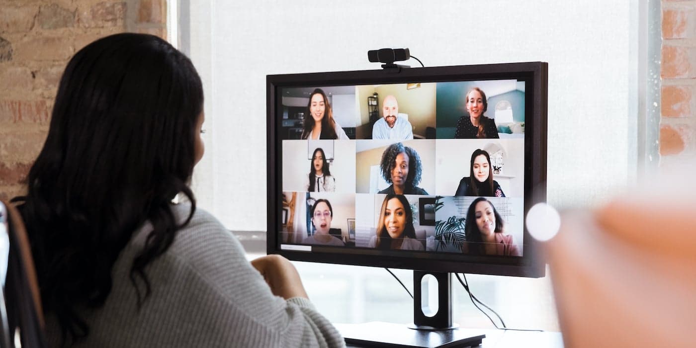 person sitting at a computer in a virtual meeting