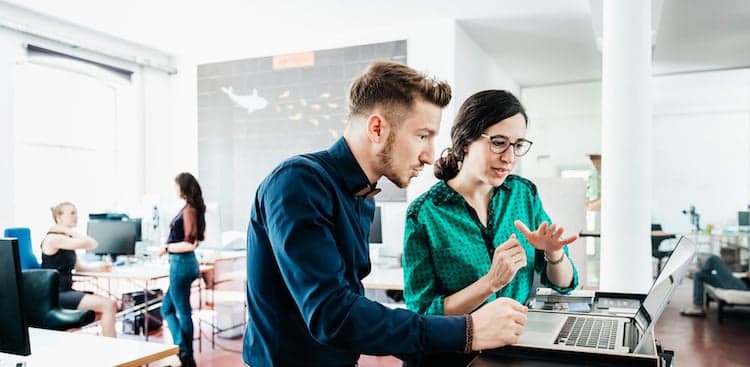 people looking at a laptop together