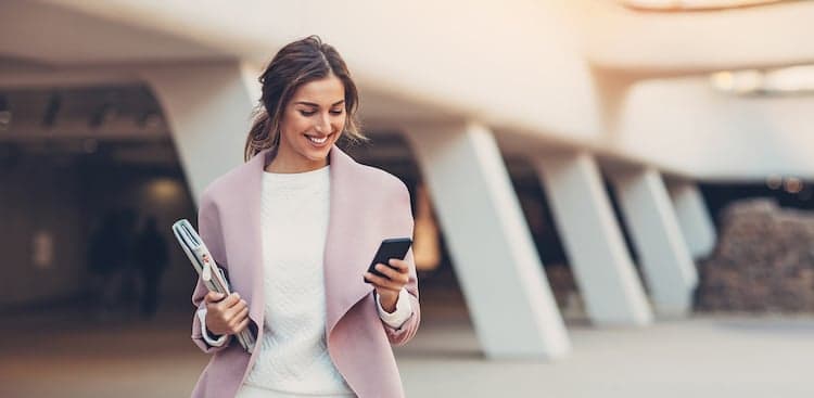 happy person checking smartphone