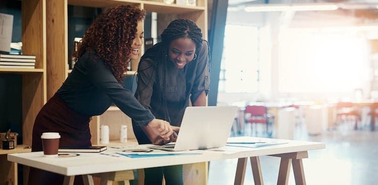 two people looking at computer
