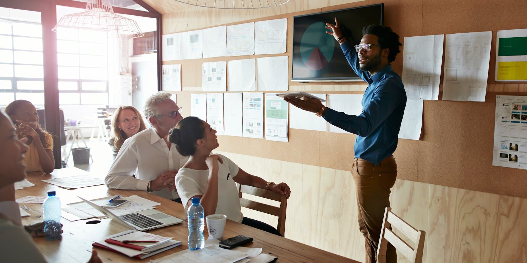 person giving presentation in conference room to group of people
