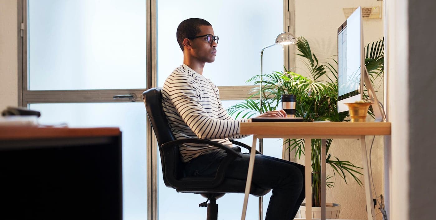 person sitting at a desk in their home office