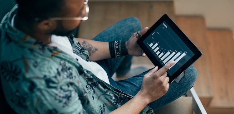 person looking at a bar chart on a tablet